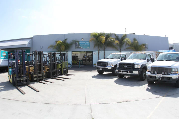 Warehouse entrance with forklifts, trucks